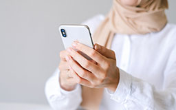 a woman accessing her account using mobile