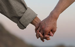 two men holding hands