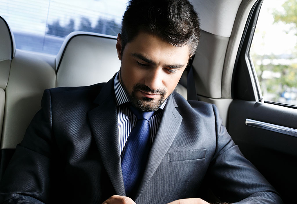 a businessman uses his mobile to view his account details