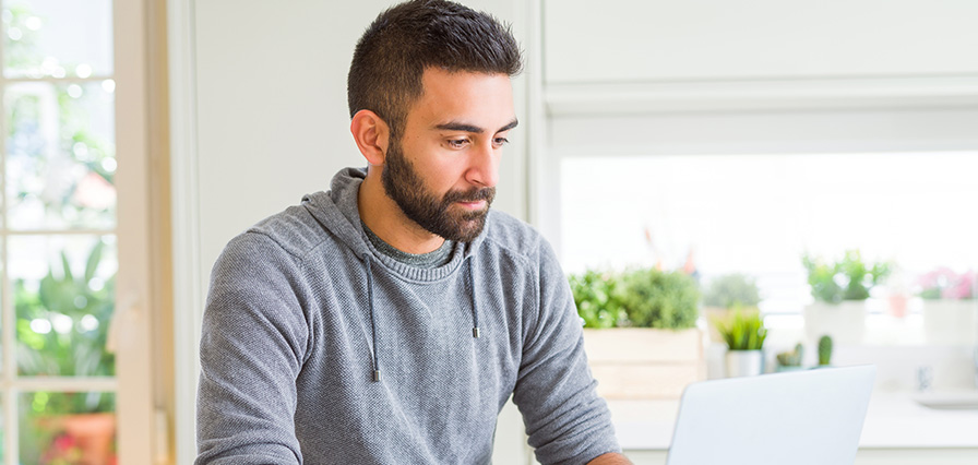 a man using his laptop to view accounts