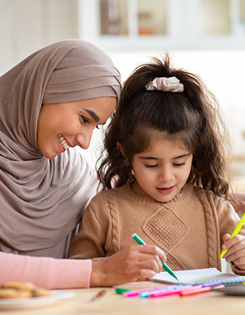 a mother teaching her daughter 
