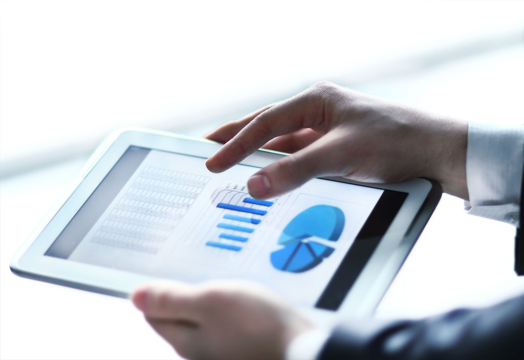 a businessman monitoring statistics on his tablet