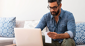 A man using his laptop to control his everyday banking needs