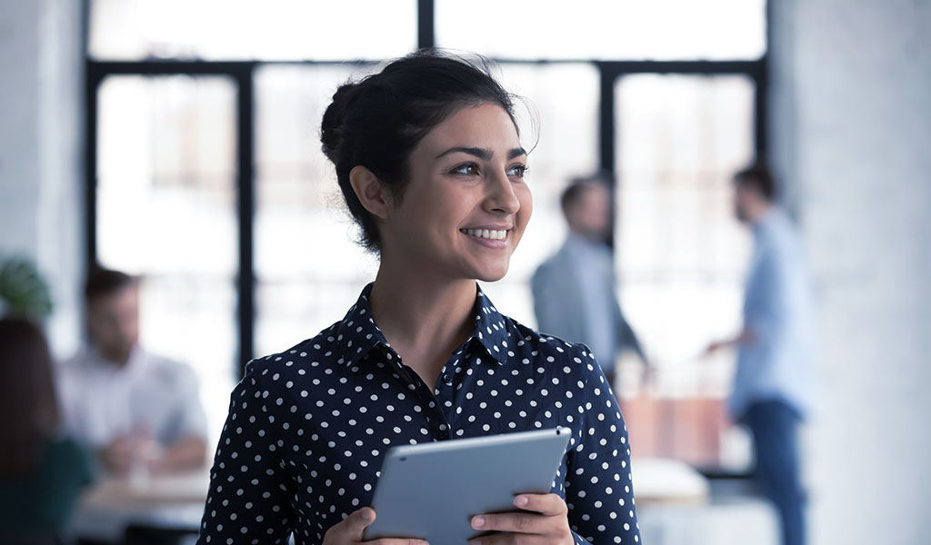 a woman carrying her tablet
