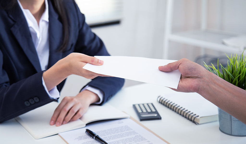 an employee handing documents to a client