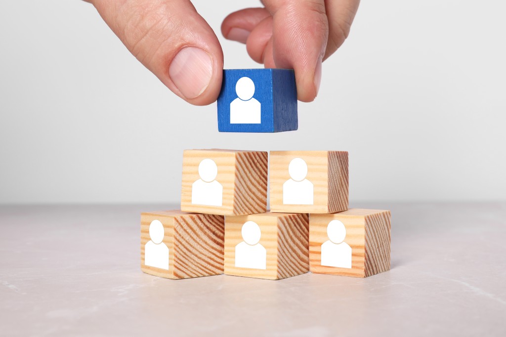human-resource-woman-stacking-pyramid-of-wooden